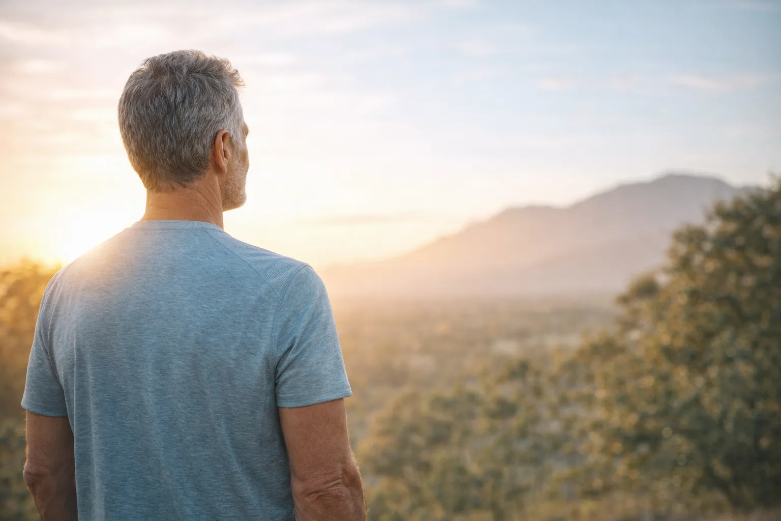 Confident mature man looking at sunrise representing hope and healthy future